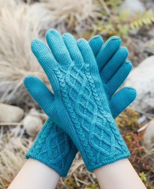 Teal gloves on hands, top-down natural setting, light background